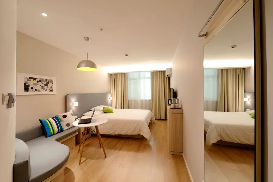 Hotel hallway with carpet and a row of guest-room doors