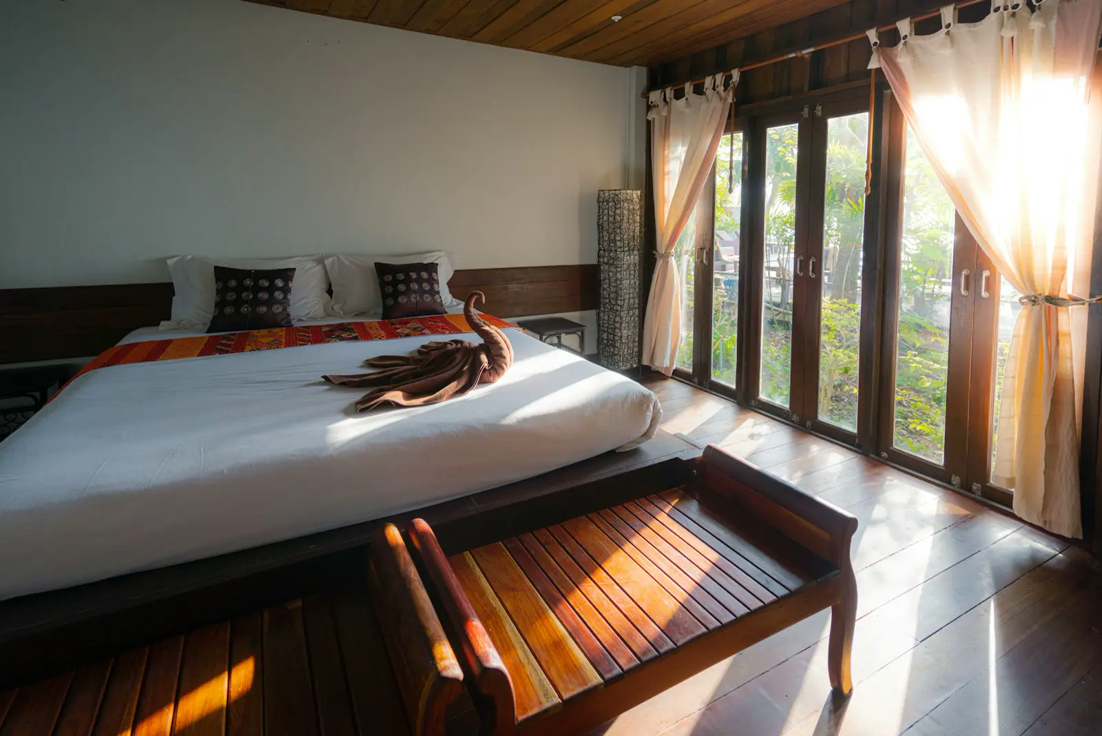 Hotel bedroom with carpet and made bed